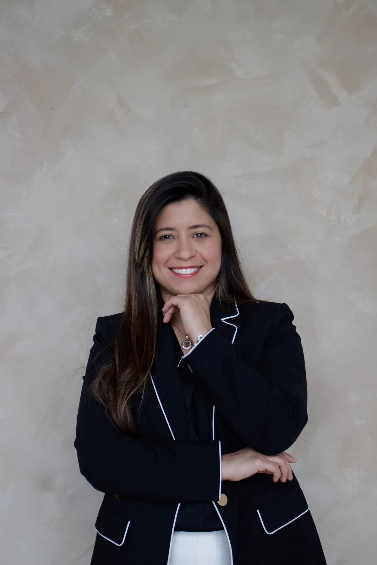 Maria Rojas smiling in a black blazer