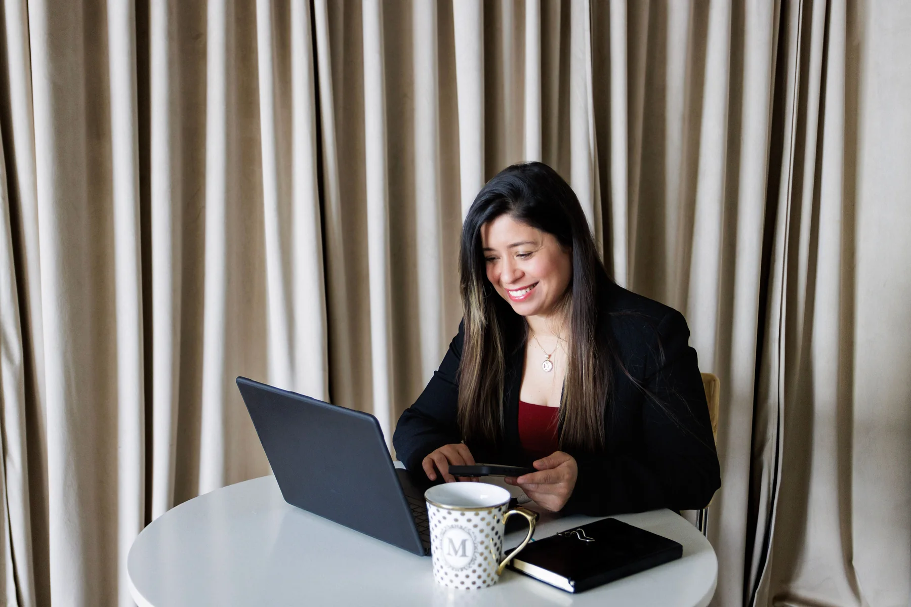 Maria Rojas working at her laptop